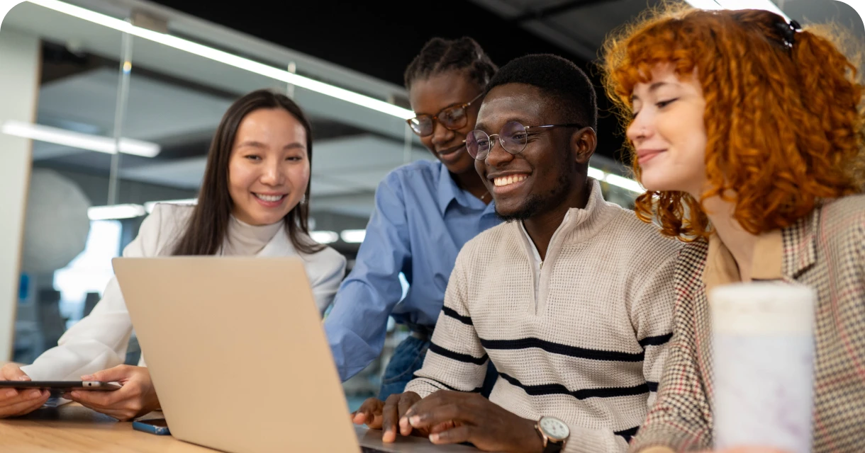 Diverse team collaborating at laptop