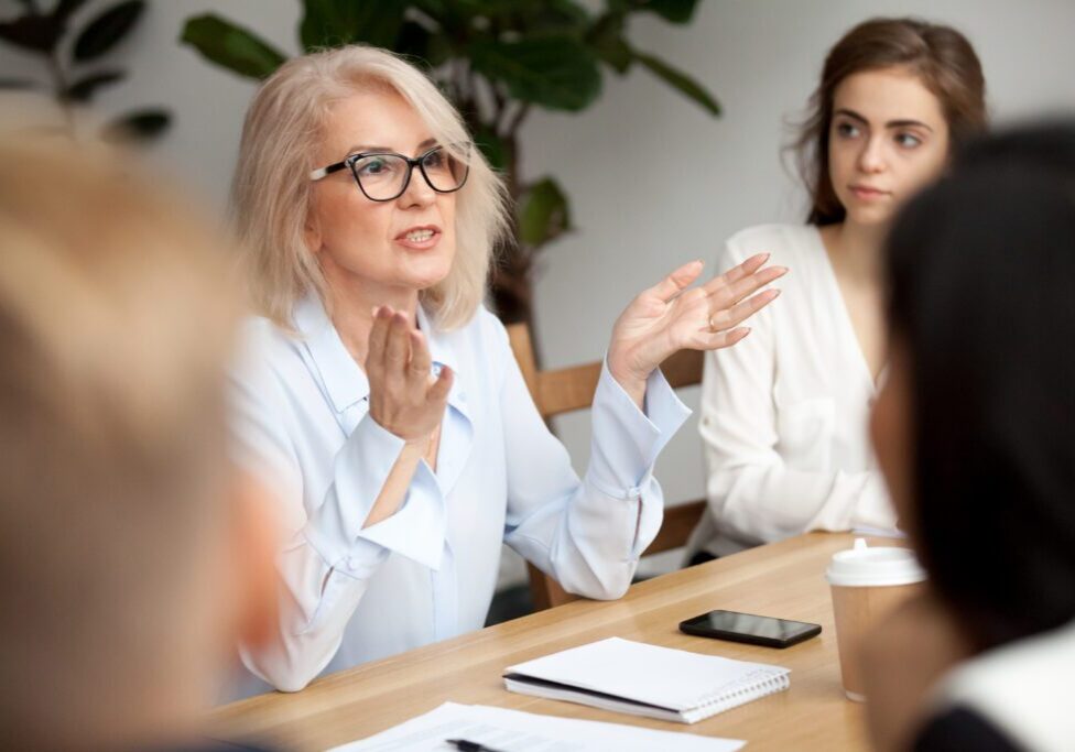 Woman explaining ideas in office meeting